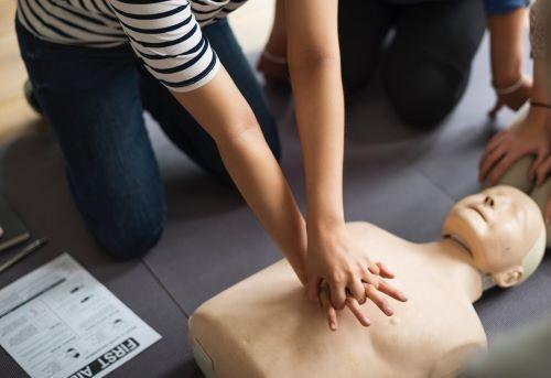person doing CPR on a CPR mannequin