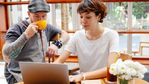 one man and one woman at a computer working.