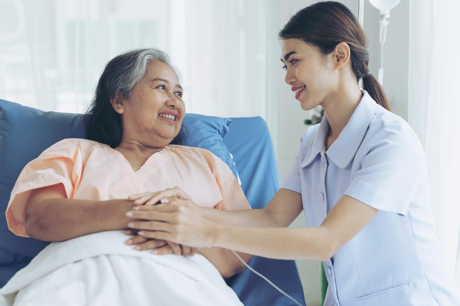 CNA student with patient who is sitting on a couch